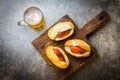 Choripan. Latin American Argentine and chilean food. Grilled chorizo sausages hot dogs served with beer, top view, stone Royalty Free Stock Photo