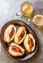 Choripan. Latin American Argentine and chilean food. Grilled chorizo sausages hot dogs served with beer, top view, stone Royalty Free Stock Photo