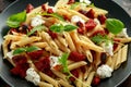 Chorizo, Penne pasta with creamy ricotta cheese and greens Royalty Free Stock Photo