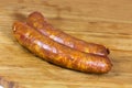 Chorizo sausage pieces on a wooden background Royalty Free Stock Photo
