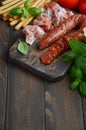 Chorizo sausage. Spanish traditional chorizo sausage and ham with fresh herbs and tomatoes. Royalty Free Stock Photo