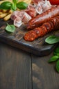 Chorizo sausage. Spanish traditional chorizo sausage and ham with fresh herbs and tomatoes. Royalty Free Stock Photo