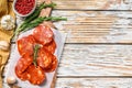 Chorizo sausage thin cut on a cutting board. Spanish salami with spices, paprika, pepper. Spicy food. White background. Top view. Royalty Free Stock Photo