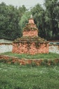 Chorten made of red colored stones in a garden in Bumthang, Bhutan Royalty Free Stock Photo