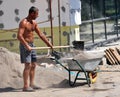 A worker loaded a mixture of a wheelbarrow