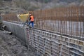 Workers pour concrete into the formwork of the wall Royalty Free Stock Photo