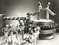 Chorus girls dancing on machine part