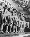 Chorus line of women with legs lifted Royalty Free Stock Photo