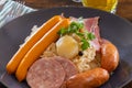 Choucroute garnie French for dressed sauerkraut is an Alsatian recipe for preparing sauerkraut with sausages and other Royalty Free Stock Photo