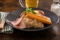 Choucroute garnie French for dressed sauerkraut is an Alsatian recipe for preparing sauerkraut with sausages and other Royalty Free Stock Photo
