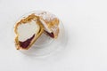 Choux Bun with whipped cream and sugar powder on top. Choux pastry dessert. French cream puff Royalty Free Stock Photo