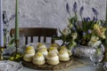 Choux Buns with Craquelin crispy cream puffs filled cream on a table decorated with spring flowers Royalty Free Stock Photo