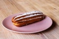 Choux pastry on pink plate on wooden background Royalty Free Stock Photo