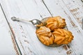 Choux pastry and spoon, on wooden background. Close Choux Cream. With a metal spoon and fork on the background