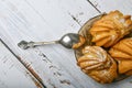 Choux pastry and spoon, on wooden background. Close Choux Cream. With a metal spoon and fork on the background