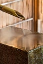 A Chozubachi - Tsukubai, a bamboo pipe dropping water on a flat stone, Kanazawa, Japan