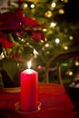 Chrismas eve at home, red candle lit Royalty Free Stock Photo