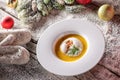Chrismas fish soup in white plate with christmas decorations, modern gastronomy