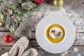 Chrismas fish soup in white plate with christmas decorations, modern gastronomy Royalty Free Stock Photo