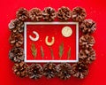 Chrismas red background with pine cones and white frame for space for text. Happy New Year and Merry Xmas post card Royalty Free Stock Photo