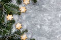 Chrismtas cookie stars and fir tree branches on gray background, holiday concept, copy space