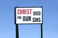 Christ died for our sins religious banner sign board against blue sky Royalty Free Stock Photo