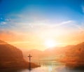 Christ Jesus birth and resurrection concept :Silhouette cross on Calvary mountain sunset background Royalty Free Stock Photo