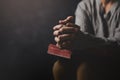 Christ religion and christianity worship or pray concept. Christian catholic woman are praying to god in dark at church. Prayer Royalty Free Stock Photo