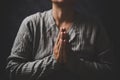 Christ religion and christianity worship or pray concept. Christian catholic woman are praying to god in dark at church. Prayer Royalty Free Stock Photo