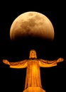 Christ statue at the Temple of the Sacred Heart of Jesus  night with the moon. Mount Tibidabo, Barcelona, Spain Royalty Free Stock Photo