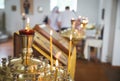 Christening in the church, Big bowl of water for the baptism of a baby with wax candles. Orthodox rite of blessing water on the Royalty Free Stock Photo