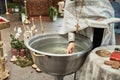 Christening in the church, priest is lighting candles at children baptismal font. Details in the orthodox christian church Royalty Free Stock Photo