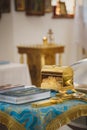 Christening in the church, golden religious utensils: bible, cross, prayer book, missal. Details in the orthodox christian church Royalty Free Stock Photo