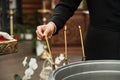 Christening in the church, priest is lighting candles at children baptismal font. Details in the orthodox christian church Royalty Free Stock Photo