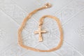 Christening details. Golden cross on a white canvas Royalty Free Stock Photo