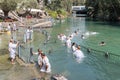 Christian believers - Catholics are immersed in the waters of the Jordan River in the Baptismal place Yardenit, where baptismal ri