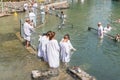 Christian believers - Catholics are immersed in the waters of the Jordan River in the Baptismal place Yardenit, where baptismal ri