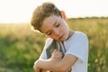 Christian boy holds bible in her hands. Reading the Holy Bible in a field during beautiful sunset Royalty Free Stock Photo