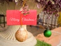 Christian Celebration Concept - Merry Christmas note with bauble in retro background.