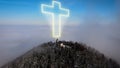 Christian chapel on mountain hilltop, with religious cross infographics