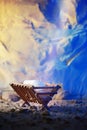 Christian Christmas concept. Birth of Jesus Christ. Wooden manger in cave background. Banner, copy space. Nativity scene Royalty Free Stock Photo