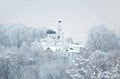 Christian church and church yard on a high hill on a snowy cold winter day Royalty Free Stock Photo