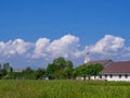 Christian church at green countryside meadow with blue sky and white clouds background Royalty Free Stock Photo