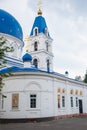 Christian Church of white stone with blue domes with stars and gold crosses.