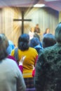 Christian congregation worship God together, with cross with light rays in background Royalty Free Stock Photo