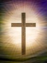 Christian cross on abstract landscape background with rays of glory. Religious Easter.