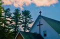 Christian cross against an ominous pink and blue sky