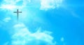 Christian cross appeared bright in the sky with soft fluffy clouds The Christian cross looks bright in the golden sky, with soft w Royalty Free Stock Photo