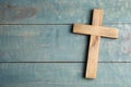 Christian cross on blue wooden background, top view with space for text. Religion concept Royalty Free Stock Photo