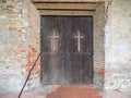 Christian cross carved in a wooden door Royalty Free Stock Photo